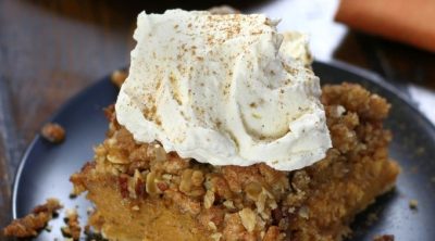 A square of Pumpkin Crisp with a big dollop of homemade whipped cream.