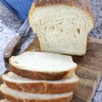 Homemade sliced Soft Sourdough on a brown cutting board.