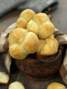 A basket full of Sourdough Clover Leaf Rolls.